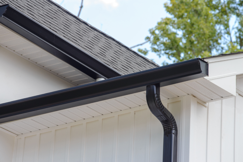 Empty unfurnished loft mansard room interior with wooden columns and wet concrete floor on roof level in black and whote style color Close-up of a black rain gutter on a home's roof edge in Colorado Springs, ideal for exterior restoration and roofing projects.