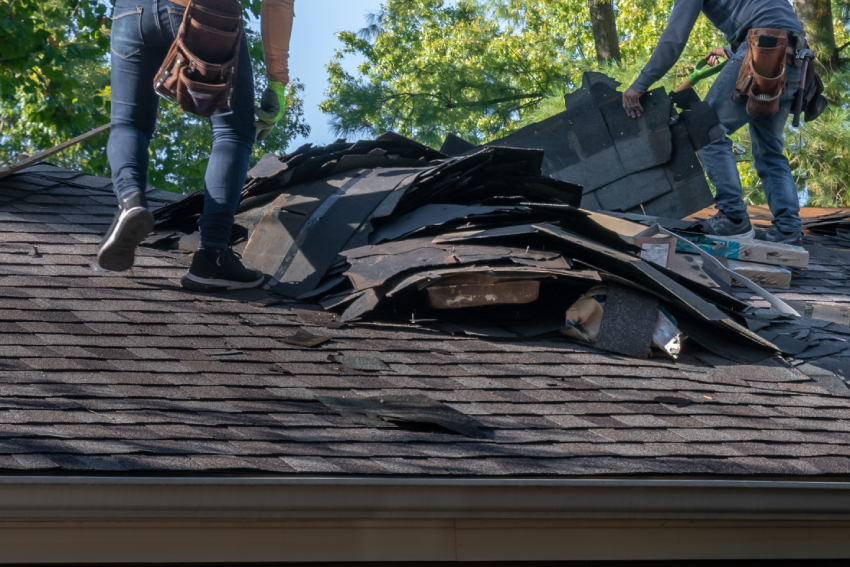Empty unfurnished loft mansard room interior with wooden columns and wet concrete floor on roof level in black and whote style color Two workers on a shingled roof in Colorado Springs remove old shingles and pile debris during an exterior home restoration job.